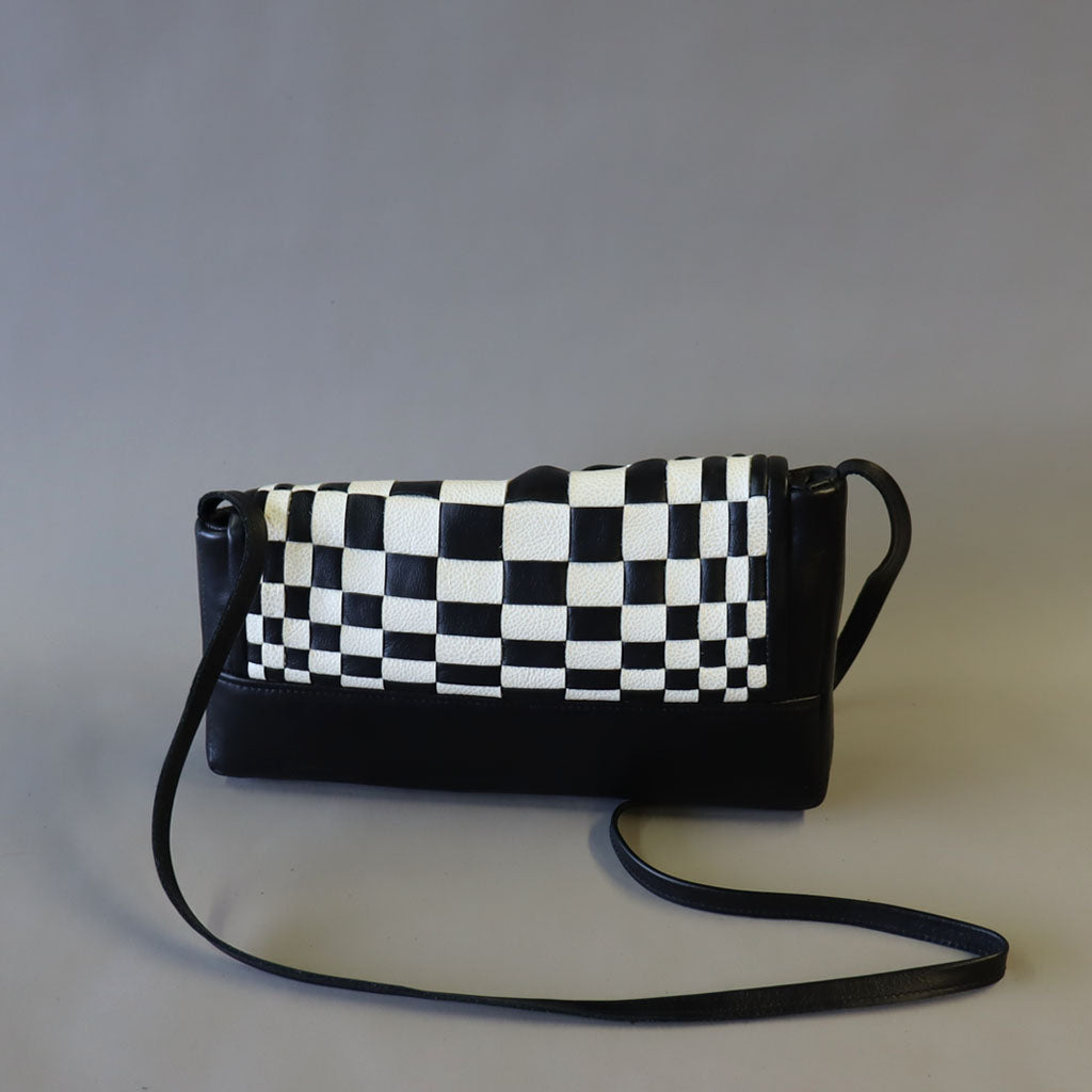 Black/ white optical weave leather bag.