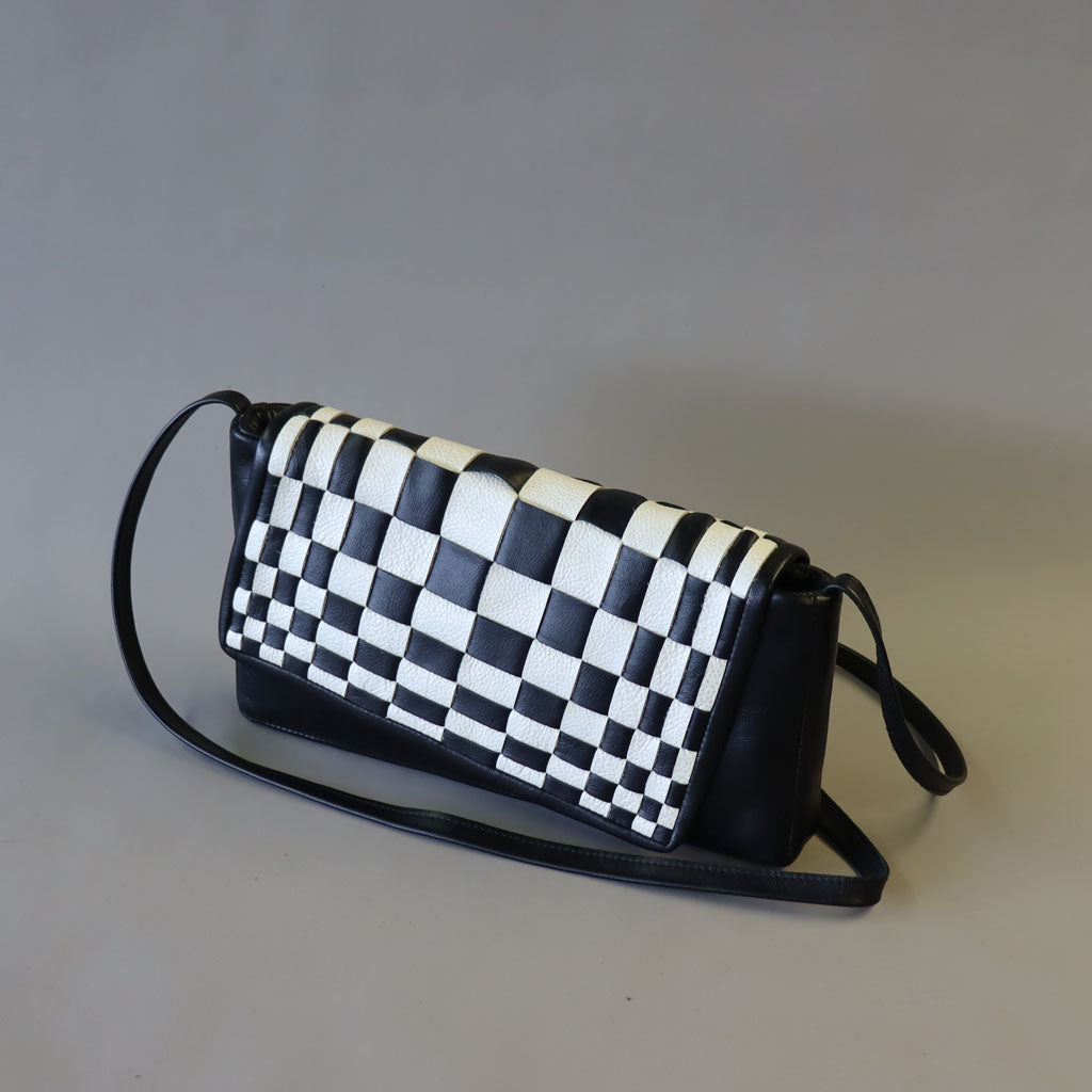 Black/ white optical weave leather bag.