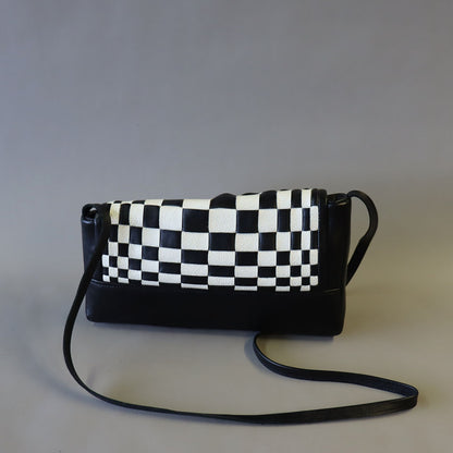 Black/ white optical weave leather bag.